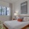 a bedroom with a bed and a plant