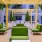 a patio with green chairs