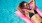 a woman laying in the pool on a float