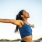 a woman with her arms out wide